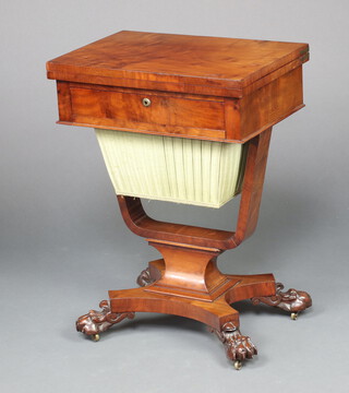 A William IV mahogany flip top games table, the base fitted a drawer and deep basket, raised on a shaped column and triform base, paw feet 72cm h x 53cm w x 35cm d  