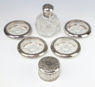 A silver mounted spherical cut glass scent bottle with silver lid, Sheffield 1915 10cm, a dressing table toilet jar and 4 plated mounted dishes