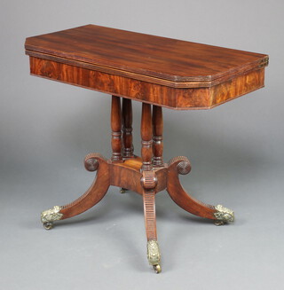 A Georgian mahogany tea table raised on 4 turned columns with triform base, splayed feet, brass caps and casters 76cm h x 91cm w x 45cm d 