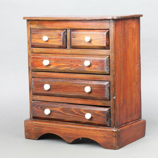 A Victorian pine apprentice chest of 2 short and 3 long drawers with ceramic handles, raised on shaped base 36cm h x 31cm w x 17cm d 