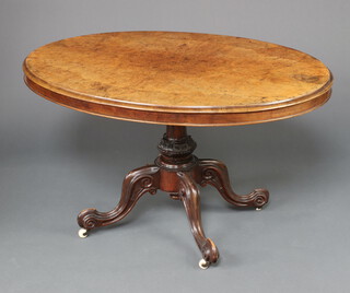 A Victorian oval figured walnut snap top Loo table raised on a turned column and tripod base 73cm h x 127cm w x 95cm d 