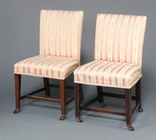 A near pair of 19th Century mahogany dining chairs upholstered in pink Regency stripe material, raised on square tapered supports with casters and H framed stretchers 81cm h x 46cm w x 40cm d 