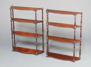 A near pair of 19th Century mahogany 4 tier wall shelves of serpentine outline and with turned columns to the sides 72cm h x 55cm w x 17cm d 