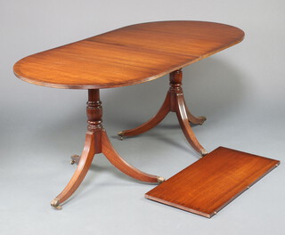 A Georgian style crossbanded mahogany D end twin pillar dining table with 1 extra leaf, raised on pillar and tripod base ending in paw caps and casters 74cm h x 88cm w x 176 l x 218cm when extended  