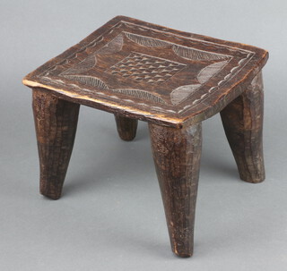 An Eastern square carved hardwood stool raised on tapered supports 23cm h x 28cm w x 25cm d 
