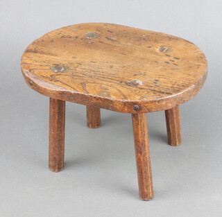 An 18th/19th Century oval elm stool raised on turned supports 19cm h x 31cm w x 23cm d 