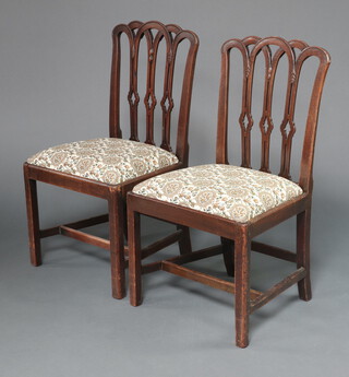 A pair of 19th Century mahogany stick and rail back chairs with upholstered drop in seats, on square supports with H framed stretcher 95cm h x 54cm w x 44cm d 