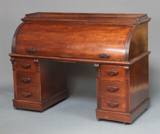 A Victorian mahogany cylinder desk with 3/4 gallery, the interior fitted pigeon holes and drawers, the base fitted 6 drawers 112cm h x 153cm w x 71cm d  