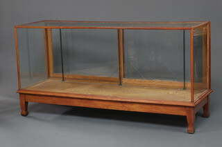 A 1930's oak and plate glass shop display cabinet 92cm h x 178cm w x 59cm d, raised on square supports (no shelves) 