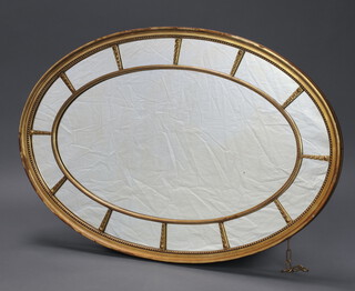 A 19th Century oval plate wall mirror contained in a decorative painted gilt frame 81cm  x 122cm 