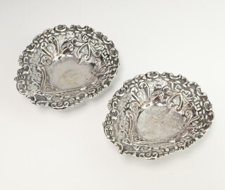 A pair of Victorian silver heart shaped bon bon dishes decorated with scrolls and ribbons Birmingham 1888, 9cm, 45 grams
