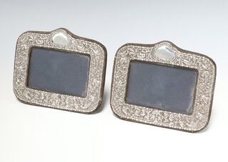 A pair of Victorian style repousse silver rectangular photograph frames London 1988 14cm x 17cm 