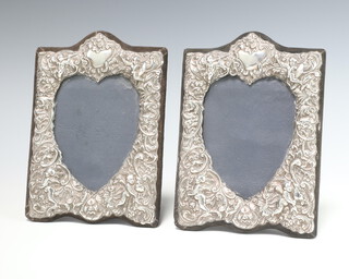 A pair of Victorian style repousse silver photograph frames decorated with cherubs London 1987 19cm x 13cm  