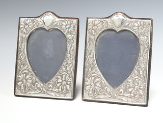 A pair of Art Nouveau style rectangular silver photograph frames decorated with flowers London 1987 19cm x 14cm 