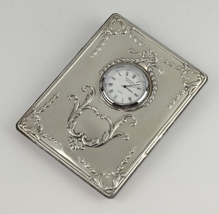 A repousse silver mounted quartz timepiece 11cm 
