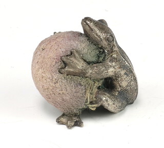 A white metal pin holder in the form of a seated frog 