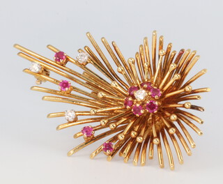 An 18ct yellow gold diamond and ruby starburst brooch, 55mm 