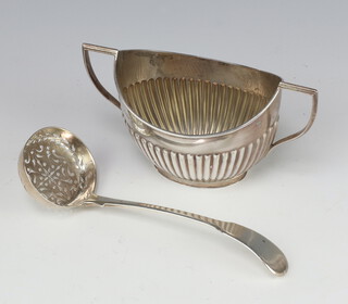 A Georgian silver sifter spoon, rubbed marks, together with a demi-fluted sugar bowl 127 grams 