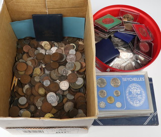 A collection of various coinage including commemorative crowns