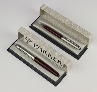 A red Parker 51 fountain pen boxed and with instructions together with a red Parker propelling pencil boxed 
