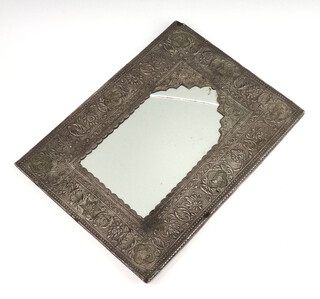 A Persian style arched plate mirror contained in an embossed metal frame 30cm x 21cm (mirror a/f)