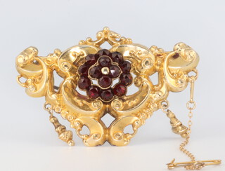 A Victorian yellow metal repousse brooch set with garnets 55mm x 40mm 