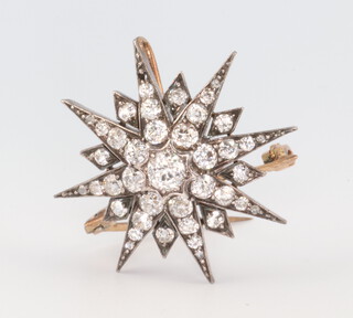 A Victorian yellow metal diamond star brooch approx. 1.7ct, 7 grams, 30mm 