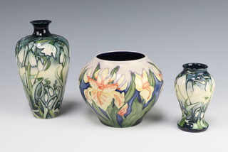 A modern Moorcroft oviform vase decorated Nivalis pattern dated 2002 15cm, a ditto 9cm dated 2002 and a baluster vase decorated Windrush pattern by Debbie Hancock, 2000 10cm 