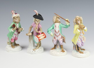 A German porcelain monkey band comprising 4 figures holding instruments raised on Rococo bases 13cm 