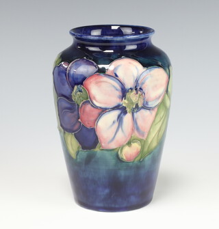 A Walter Moorcroft blue ground baluster vase decorated the clematis pattern with paper label and marks to base 15cm 