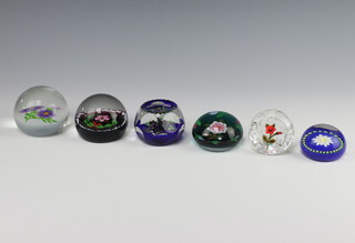 A William Manson glass limited edition paperweight - Michaelmas Daisy no.113 of 250 7cm, ditto of flowers dated 2007 7cm, another faceted and dated 2002 7cm, a moulded ditto 2007 6cm, a Caithness ditto decorated with holly no.80 of 250 8cm and a Joyce Manson paperweight decorated flowers no.19 of 20 dated 2002 6.5cm  