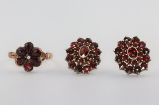 A yellow metal garnet set ring size L, a pair of ditto ear studs 