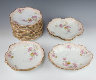 A Limoges dessert service decorated with spring flowers and gilt rims comprising 12 plates, 2 circular bowls (1 cracked), 2 oval dishes, 2 scalloped dishes 