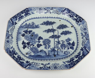 An 18th Century Chinese blue and white octagonal meat plate decorated with a landscape scene with trees and flowers 45cm 