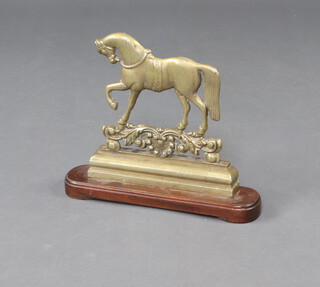 A 19th Century brass and mahogany door stop in the form of a walking horse 35cm h x 39cm w x 9cm d 
