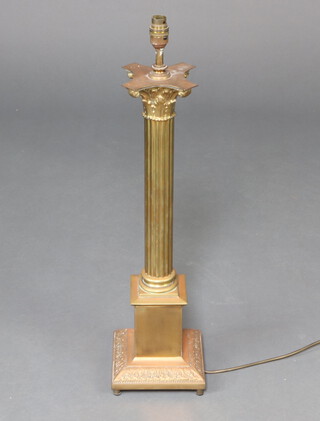 A gilt metal table lamp in the form of a reeded column with Corinthian capital, raised on a square base 60cm h x 17cm 