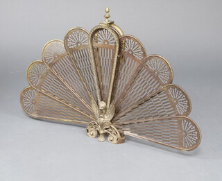 A Victorian style pierced gilt metal peacock spark guard 62cm h x 91cm w 