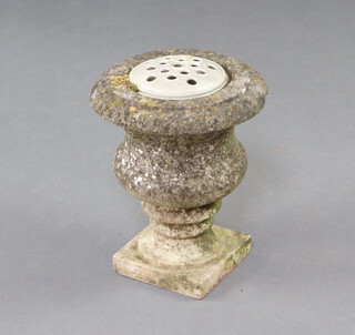 A carved stone urn of baluster form on a square base 30cm h x 25cm 