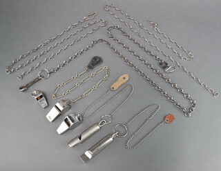 A Halex whistle, an Acme Thunderer whistle, 3 long whistles, 3 chains 