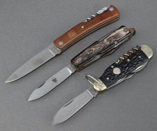 A Perceval folding pocket knife with 8cm blade with corkscrew and wooden grip, a Boker Tree Brand multi bladed pocket knife with 6cm blade marked Tree Brand Classic 182 with 2 bottle openers, 2 blades, corkscrew and pick with simulated horn grip, a multi bladed pocket knife with 3 blades, screwdriver, corkscrew and pick with horn grip  