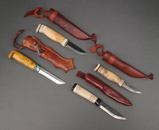 Three Swedish skinning knives with wooden grips and leather scabbards together with 1 other with a bone grip and leather scabbard