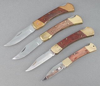 Four Chinese folding knives with hardwood and brass grips 