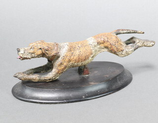 A cold painted bronze figure of a running hound raised on an oval base 5cm x 23cm x 3cm 