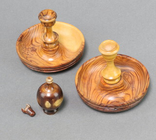 A pair of olive wood campaign style candlesticks 8cm x 9cm together with a small turned wooden bottle (chip to rim) 