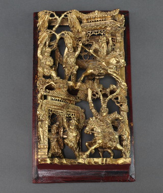 A Chinese carved and pierced gilt plaque depicting mounted warriors 27cm x 15cm 