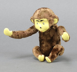 A clockwork figure of a monkey with tinplate face 14cm 