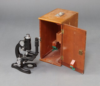 A Beck of London model 3228 binocular microscope cased in a wooden box with broad arrow marked HFZ.13117  