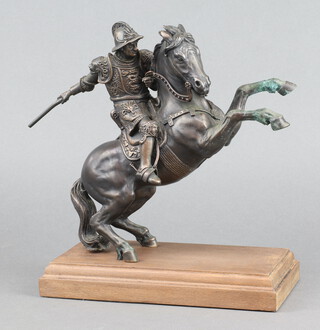 A Franklin Mint bronze figure of a mounted warrior raised on a rectangular mahogany base 29cm h 
