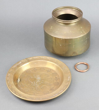 A copper bull ring 6.5cm, an embossed brass dish decorated a bird 27cm, an Eastern brass tin 22cm h 