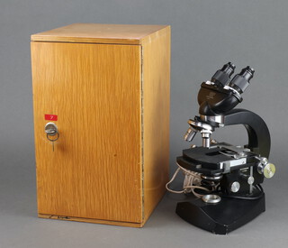 A Czechoslovakian Praha electric binocular microscope cased 
